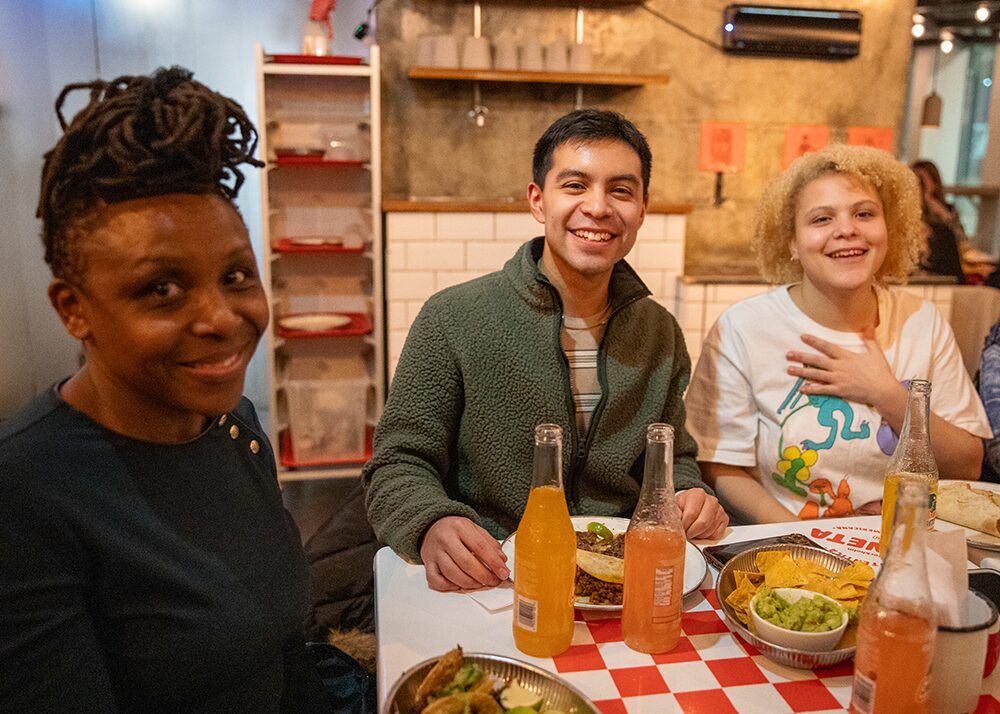 Nyamusi and students at La Neta, a Mexican restaurant