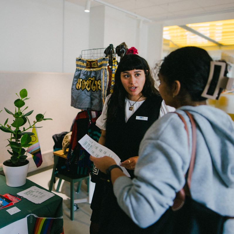 Erika converses with a student at the Activities Fair.